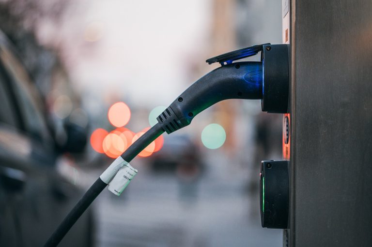 Old EV Batteries Are Becoming a Valuable Harvest An electric car plugged in and charging, its battery destined one day for recycling